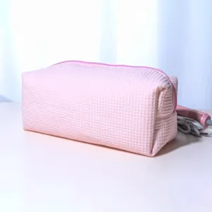Pink waffle makeup and hairdryer storage bag, padded large capacity portable travel cosmetic case.