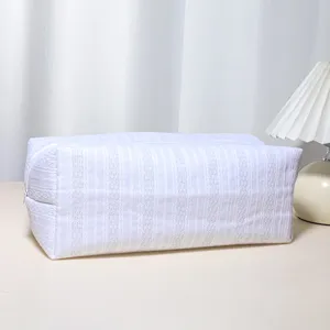 White quilted storage bag for hair styling tools, large capacity cosmetic zipper pouch detail.