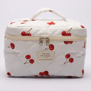 Quilted cotton cosmetic bag with cute cherry print, portable travel makeup storage pouch.