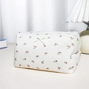 Detailed view of large capacity waffle cosmetic bag with cute bow and floral print for travel.