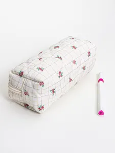 Quilted floral cosmetic bag detail view, showing the durable zipper and soft fabric texture.