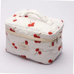 White quilted cherry cosmetic bag, cute makeup pouch with handle and zipper for travel storage.