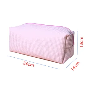Pink waffle pattern storage bag detail showing padded compartment and dimensions for beauty tools.