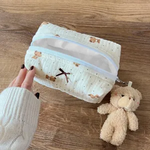 Cute seersucker cosmetic bag with bear print, bow and fluffy bear pendant for daily travel.