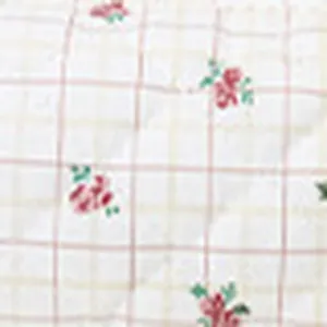 Quilted cosmetic bag fabric detail, elegant white plaid with vintage red floral print.