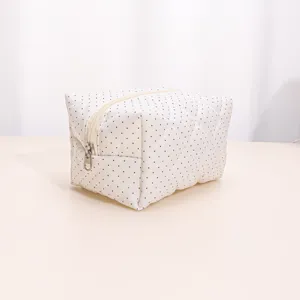 Quilted polka dot cosmetic bag detail, soft portable makeup organizer pouch for daily use.