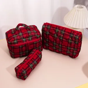 Red plaid quilted cosmetic bag detail display, portable travel makeup storage pouch view.