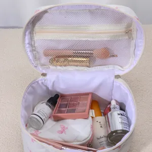 Detailed view of quilted travel cosmetic bag interior, spacious mesh pockets for daily storage.