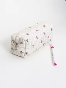 Quilted floral cosmetic bag detail view, showing soft fabric texture, cute plaid and zipper.