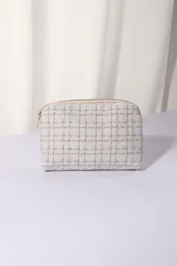White tweed cosmetic pouch detail, elegant woven zipper makeup bag close up view for daily use.