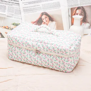 Quilted floral makeup bag with handle and zipper, portable travel storage bag for hair tools.