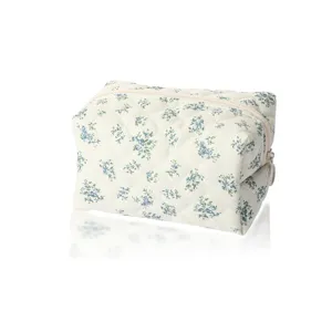 Quilted floral makeup pouch, aesthetic cosmetic storage bag with zipper for travel and daily use.