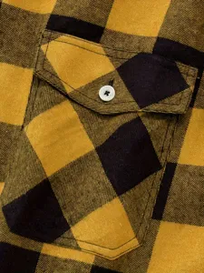 Close up view of men's yellow and black plaid flannel shirt pocket detail with soft fabric texture.