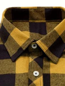 Detailed view of men's yellow and navy plaid flannel shirt collar and white button close-up.