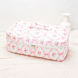 Quilted hair tool travel storage bag with pink floral ribbon print, detailed zip pocket view.
