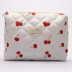 Quilted cosmetic bag with cute cherry pattern, soft cotton travel makeup pouch for daily use.