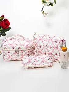 Quilted cosmetic bag set featuring floral ribbon print, soft padded portable makeup storage pouch detail.