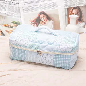 Quilted floral cosmetic bag with handle, portable travel storage bag for hair tools.