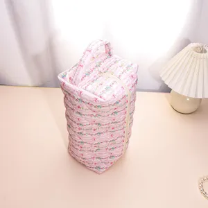 Detailed view of the pink floral quilted storage bag featuring soft padded fabric and zipper.