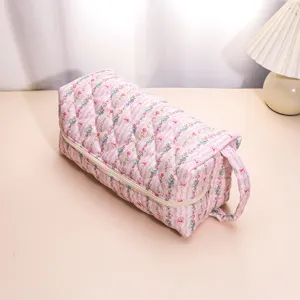 Detailed view of the pink floral quilted storage bag showing soft padded fabric and zipper.