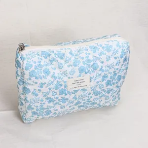 Blue floral quilted cosmetic bag, large capacity soft travel makeup pouch for women.