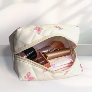 Detailed view of the quilted cosmetic bag showing interior space with makeup brushes and storage.