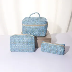 Blue tweed cosmetic bag set with large vanity case, medium pouch, and small brush pencil bag.