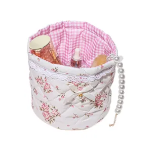 Cute floral quilted storage basket with lace trim, sweet bow and elegant pearl handle.