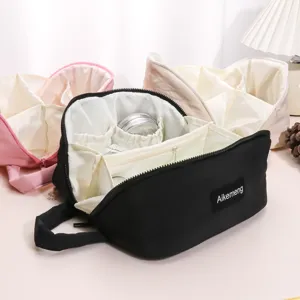 Minimalist solid color puffy cosmetic bag with large capacity, waterproof and multi-compartments.