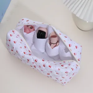 Quilted hair dryer storage bag with inner compartments, portable travel organizer case.