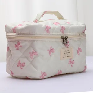Quilted cosmetic bag featuring sweet pink bows, cotton padded portable travel makeup storage.