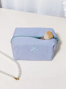 Blue and white striped cosmetic bag with bow, large capacity portable makeup organizer pouch.