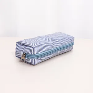 Blue and white striped cosmetic bag detail view, portable zipper pouch for travel and daily storage.