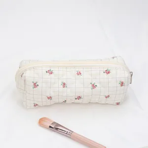 Quilted floral cosmetic bag, portable travel storage pouch with zipper closure, main view.