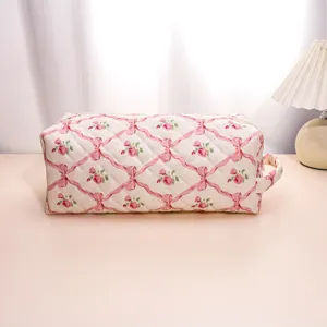 Quilted floral cosmetic bag, portable travel makeup pouch, hair tool storage organizer.
