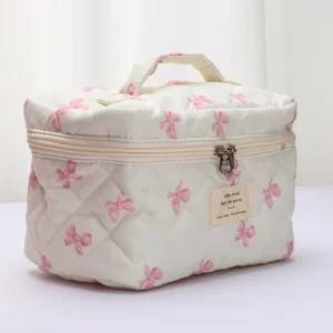 Quilted bow makeup bag, large capacity portable cosmetic pouch for women and daily storage.