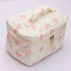 Quilted makeup bag with sweet pink bow pattern, large capacity portable storage for travel daily use.