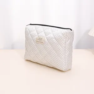 Quilted cosmetic bag with small polka dots, soft large capacity storage pouch for daily use.