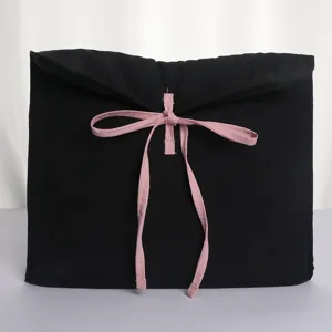 Black quilted laptop sleeve with pink bow strap, ballet core style tablet case for women.