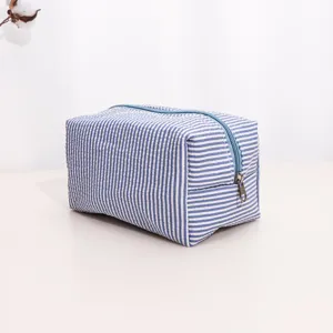 Blue and white striped makeup bag, portable toiletry pouch, travel storage organizer.