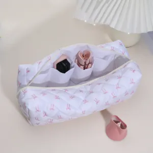 White quilted cosmetic bag with pink bow pattern, travel storage organizer for hair tools.