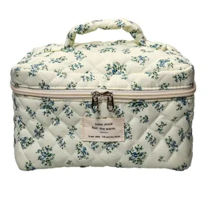 Quilted floral cosmetic bag with handle and zipper, soft storage bag for daily use.