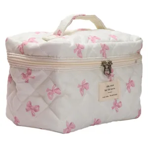 Cute quilted bow makeup bag with large capacity, portable storage for daily travel.