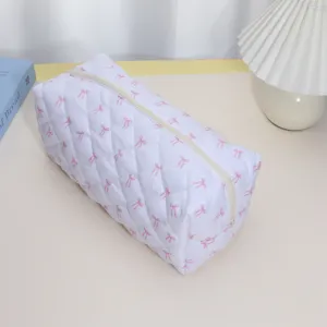 Quilted hair dryer storage bag with pink bow pattern, large capacity cosmetic and travel organizer.
