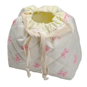 Quilted cosmetic storage bag with cute pink bows, portable drawstring makeup pouch for travel.