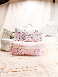 Quilted floral cosmetic bag large capacity portable travel toiletry storage bag with handle.