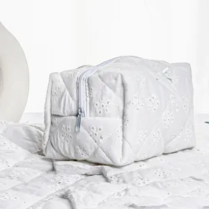 White quilted embroidered cosmetic bag, cotton toiletry pouch with zipper and lace detail.