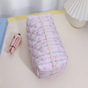 Quilted pink floral storage pouch detail showing soft padded texture and sturdy white zipper.