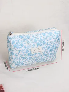 Quilted blue floral cosmetic bag detail view, showing soft fabric, stitching and zipper.