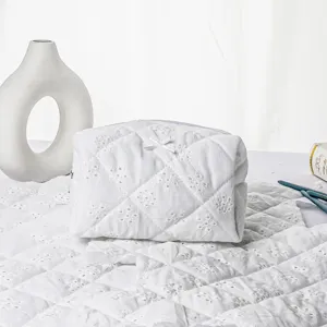 White quilted embroidered cosmetic bag cotton wash bag detail view for daily travel use.